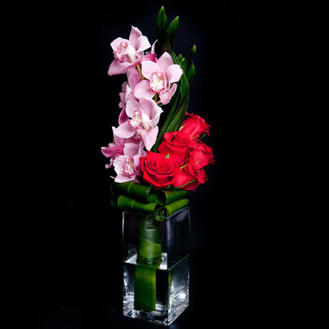 Cymbidium Orchids and Roses in a Simple Glass Container
